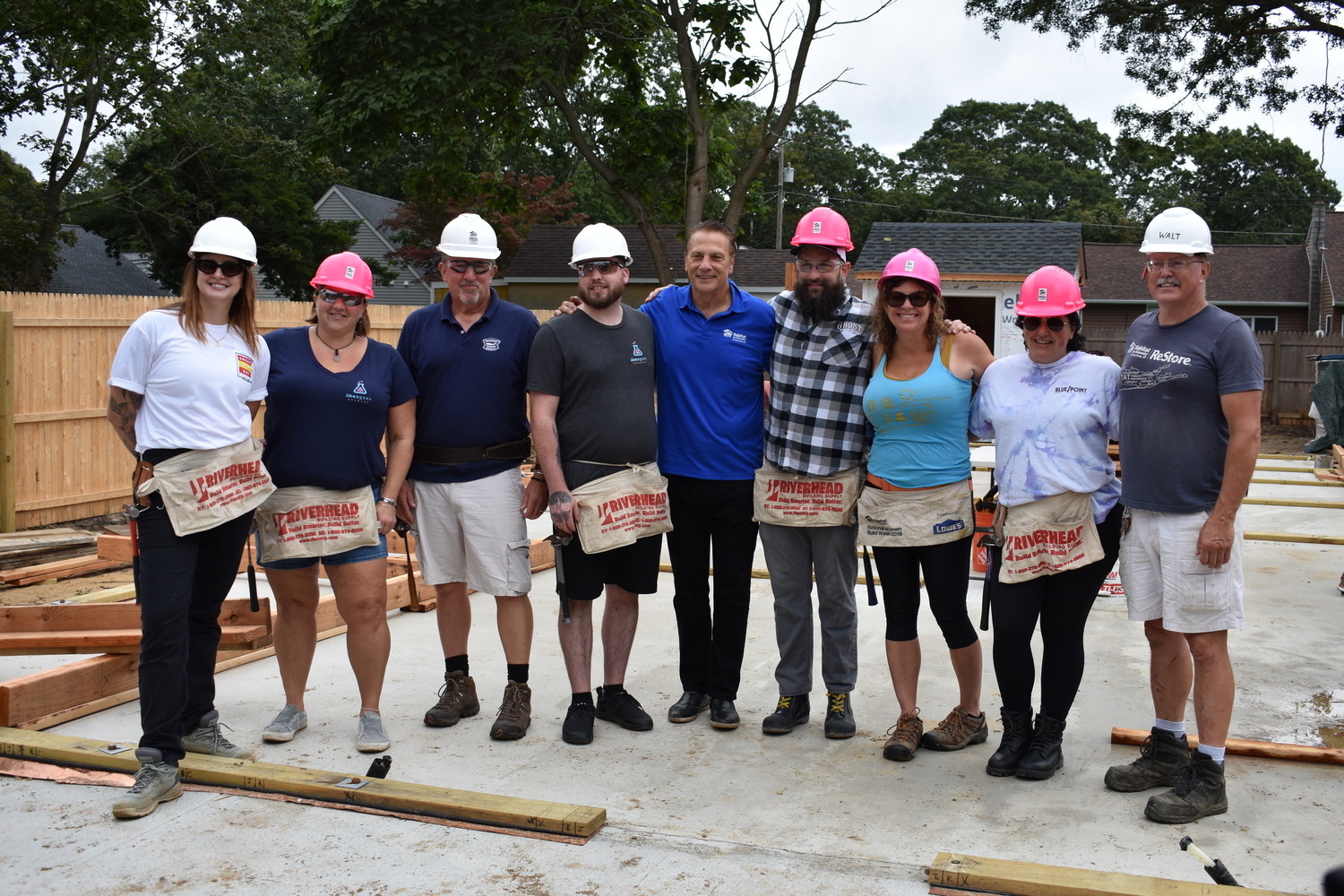 Habitat for Humanity of Long Island CEO Jimmy Jack, center, flanked by House Beer Built wall-raising crew members and, on the far right, construction supervisor Walt Mackey. BRENDAN J. O'REILLY