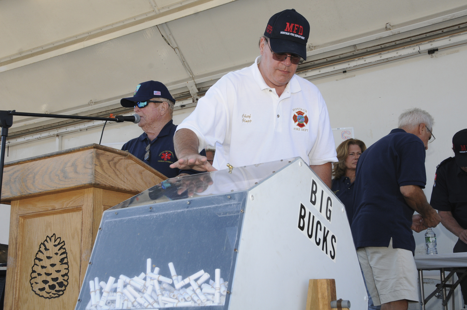Montauk Fire Department Treasurer Dick White and Chief Ken Glogg at the 40th annual  Montauk Fire Department Big Bucks Bonanza on Sunday at the firehouse. Music was provided by the local Nancy Atlas Project and special guest musician Joe Delia. Proceeds from the Bonanza go to a Scholarship Fund for Montauk youths. Each scholarship is in memory of a Montauk fireman who worked at Montauk School:  Custodian Don Truesdale; Athletic Director Hank Zebrowski; Crossing Guard Skip Cannon; and Superintendent  Bob Fisher. To date, the Big Bucks Bonanza prize drawing has given away Scholarship prize money totaling almost $5,000,000.   RICHARD LEWIN