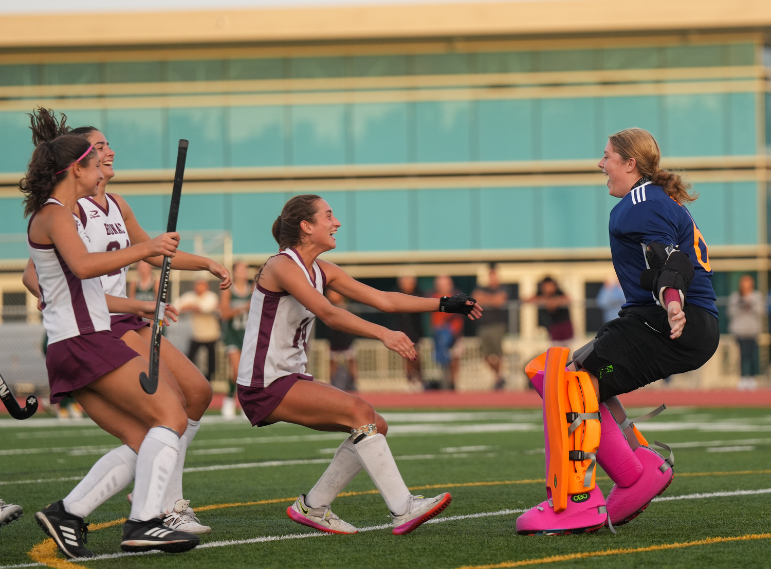 East Hampton's Emma McGrory runs to embrace goalie Caeleigh Schuster after their team's shootout win over Harborfields. RON ESPOSITO