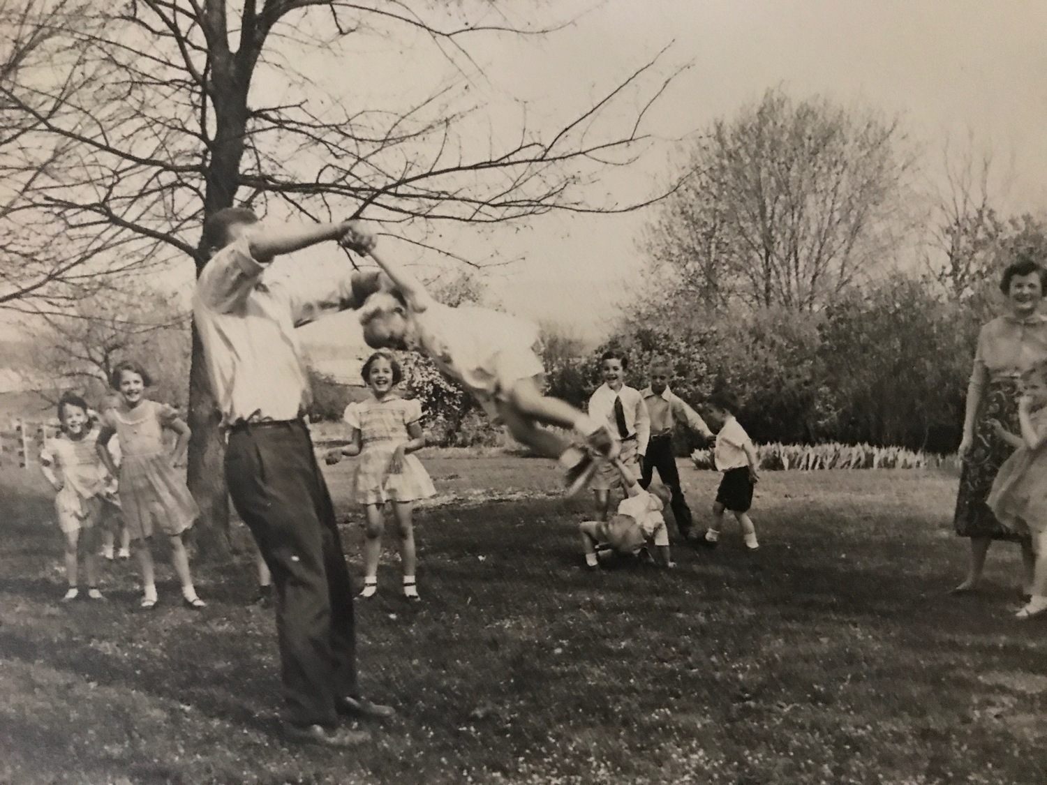 Frazer Dougherty twirls his daughter, Ariel, during a family gathering in 1953. COURTESY ARIEL DOUGHERTY