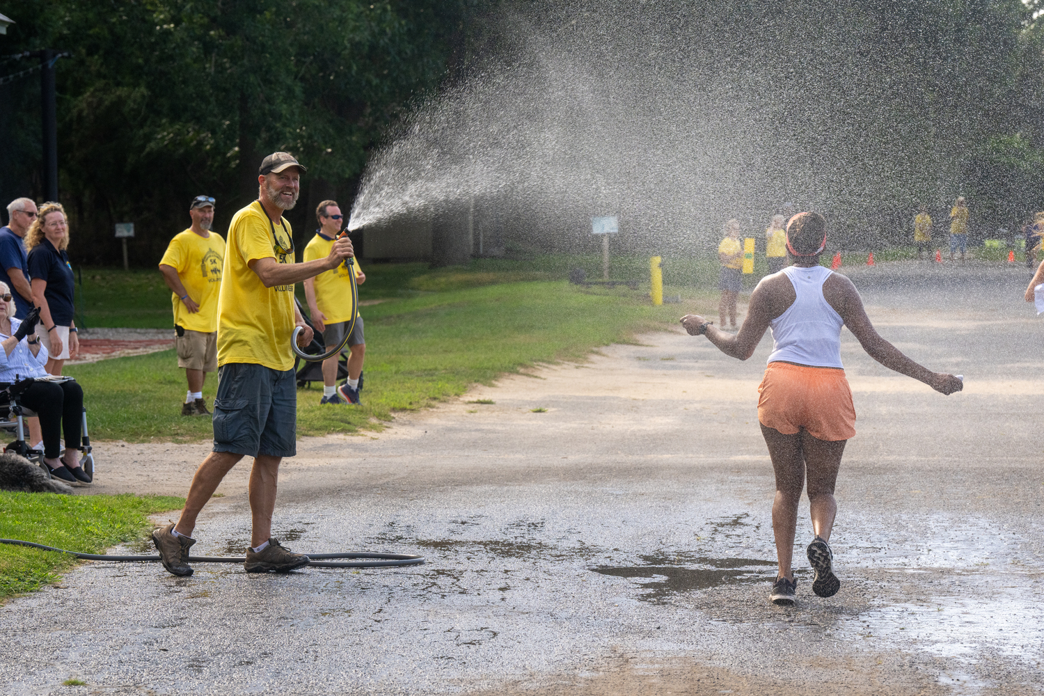 Race organizers try to keep runners and walkers cool during a late summer heat wave.   RON ESPOSITO