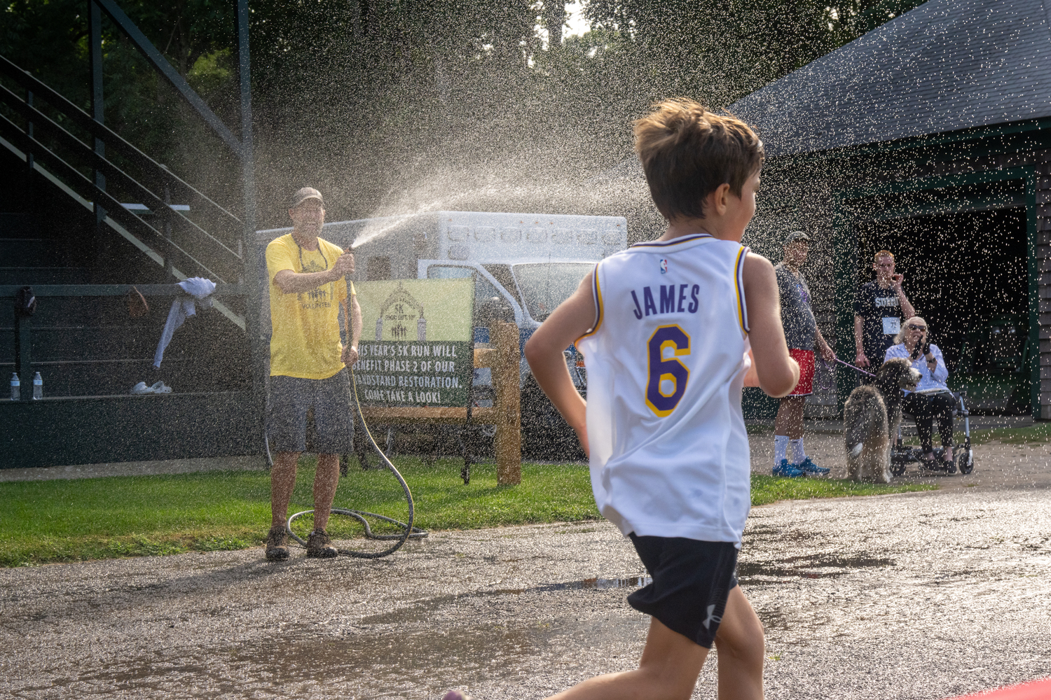 Race organizers try to keep runners and walkers cool during a late summer heat wave.   RON ESPOSITO