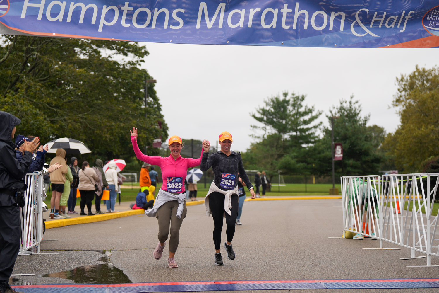 Jennifer Taylor, left, and Charly Dahlquist cross the finish line together in the marathon.   RON ESPOSITO