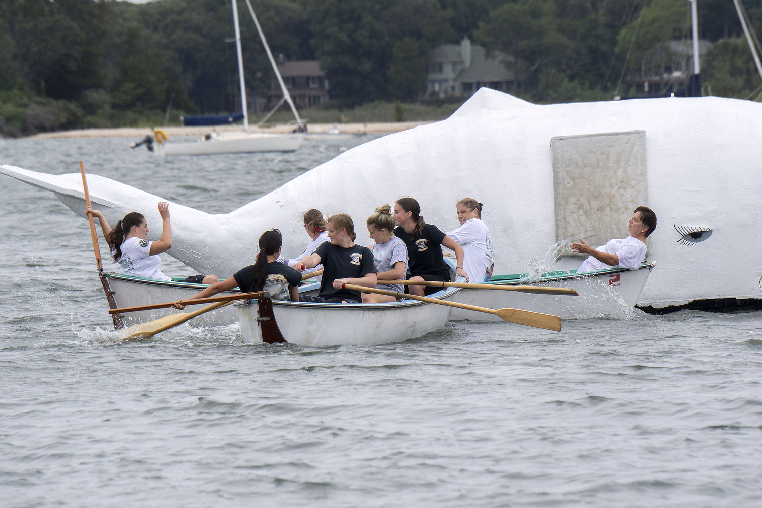 The Corner Bar and Lady Whalers women's whaleboat teams get tangled up with each other during the 2018 HarborFest celebration.   MICHAEL HELLER