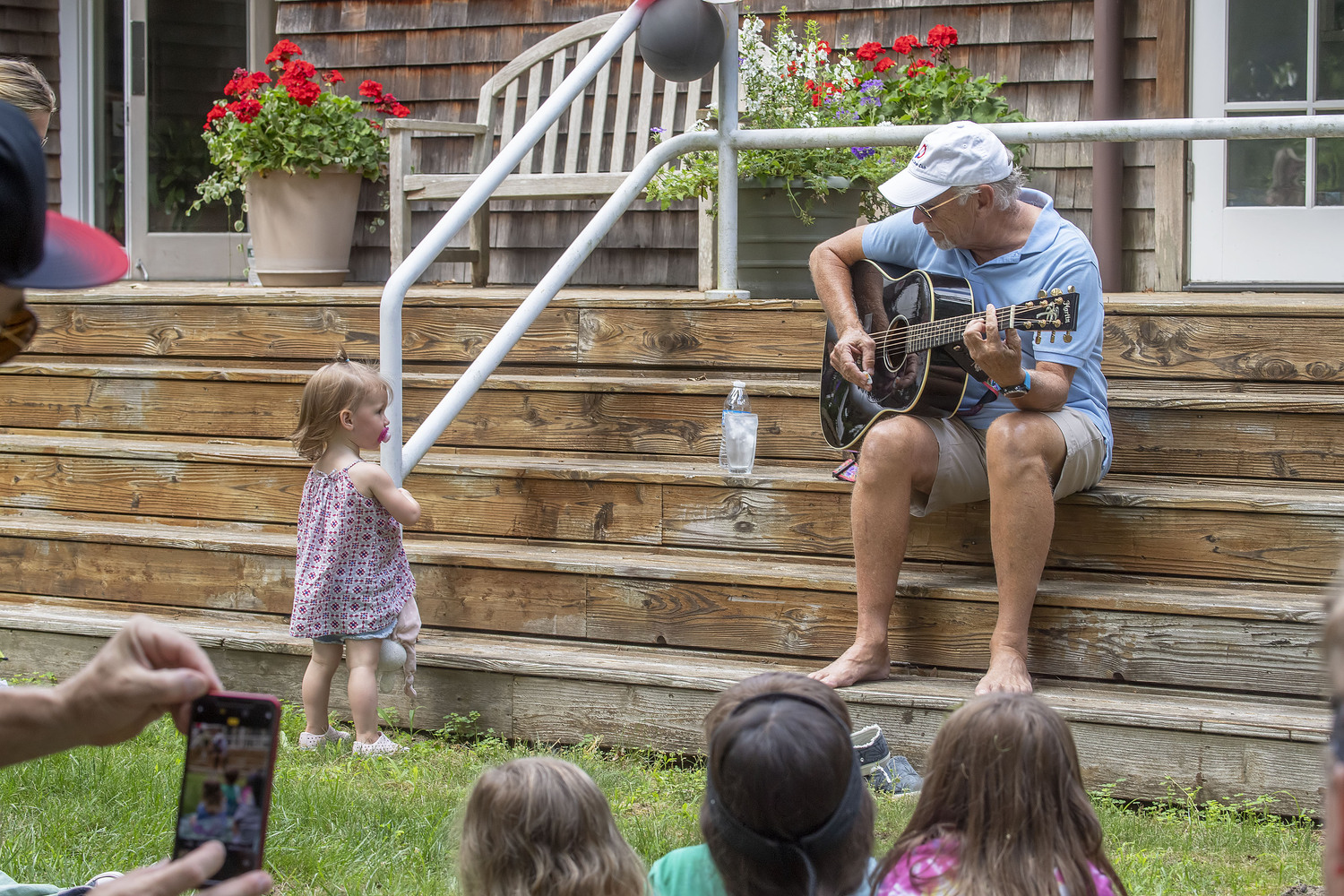 Jimmy Buffett performs at he grand opening of the newly-renovated playground behind North Village Hall on July 5, 2019.    MICHAEL HELLER