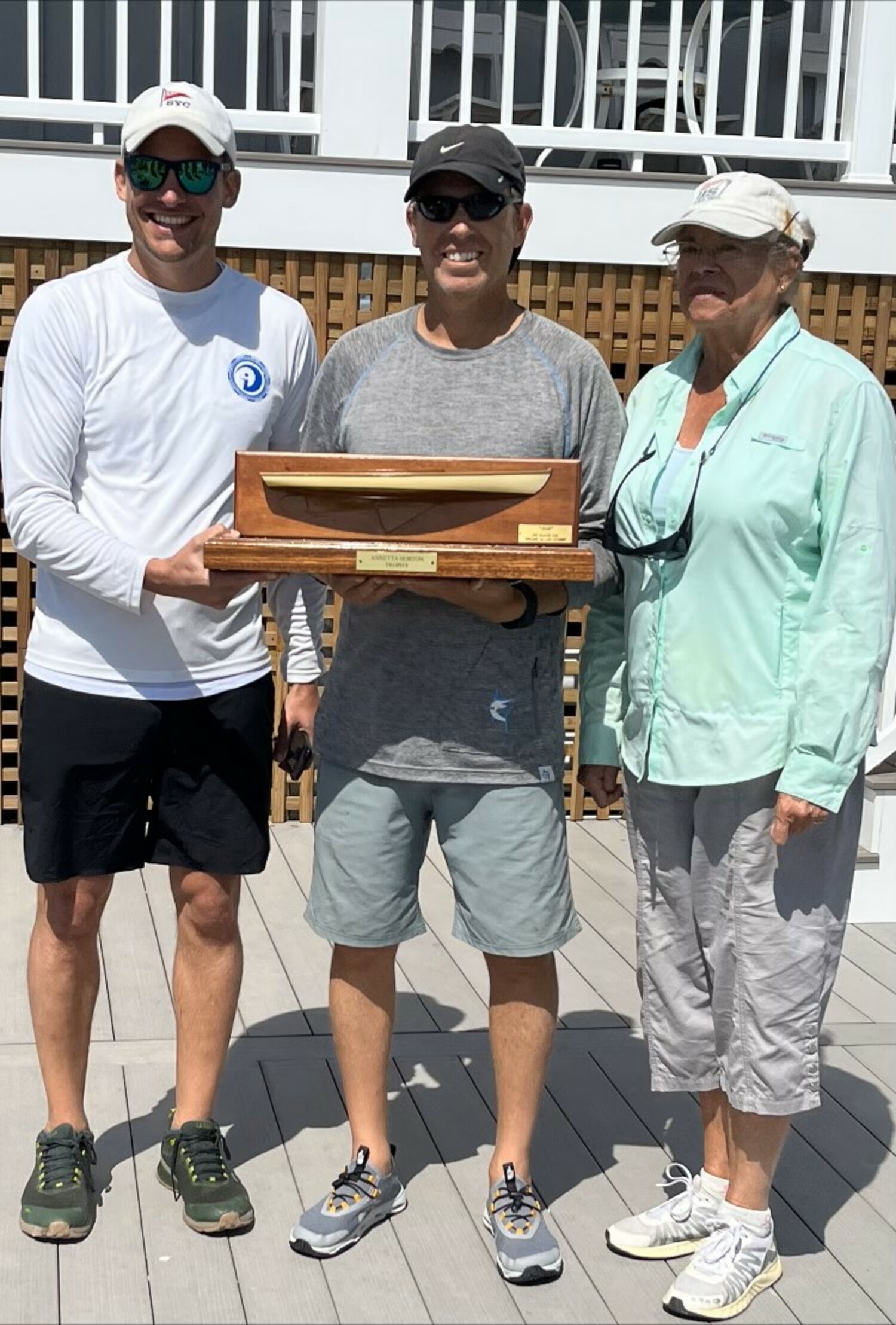 Ian Connett, left, Michael Nelson and Helen Horton with the Annetta Horton Trophy, which they won on Saturday.