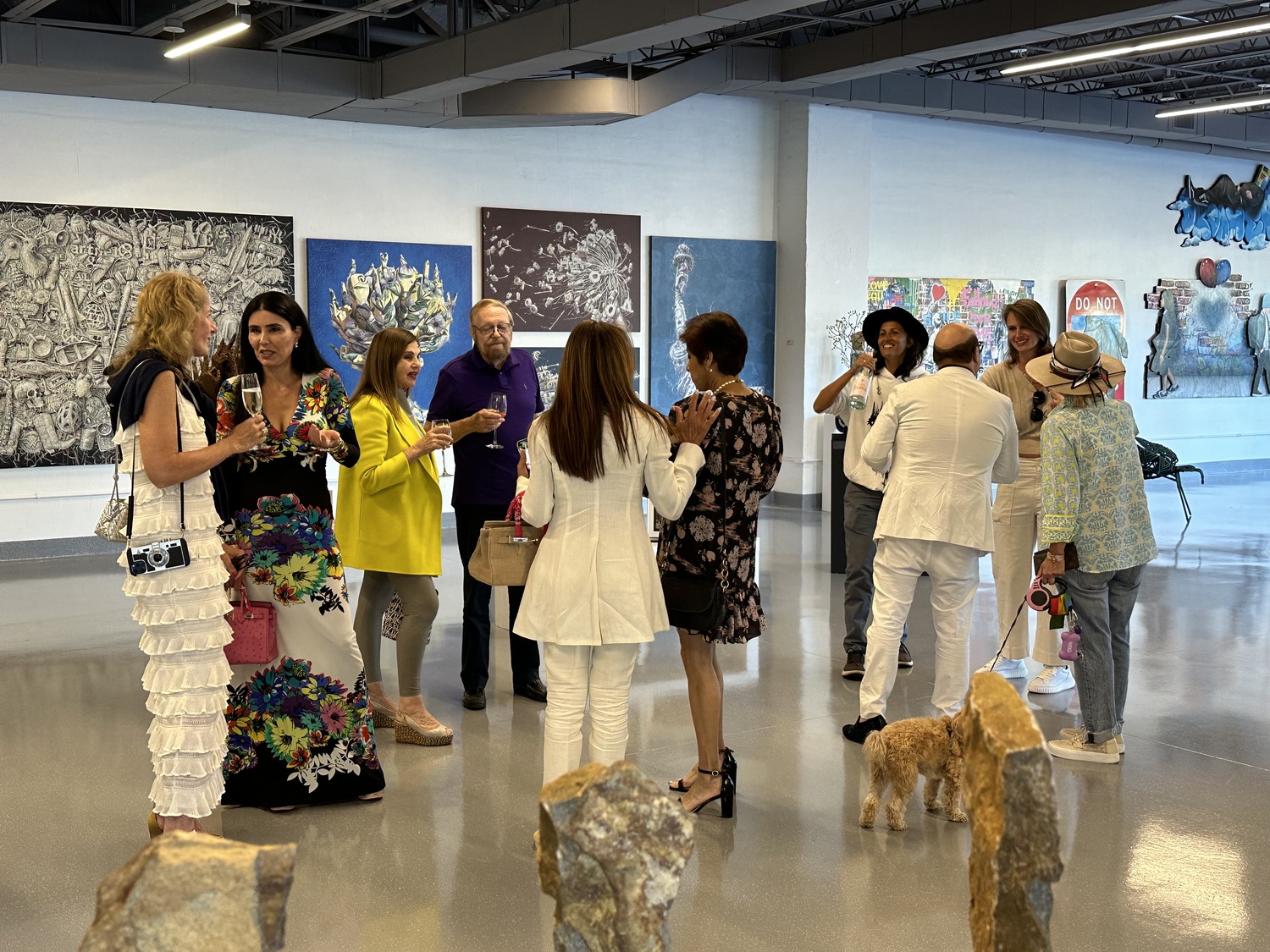 Guests admiring artwork at the Contessa Gallery, which opened in the art deco building at 1 Pond Lane in Southampton Village this summer. GREG DELIA