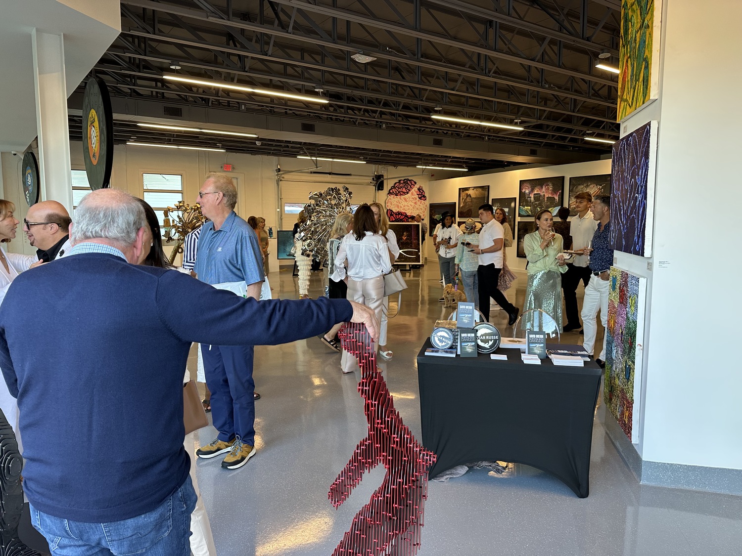 Guests admiring artwork at the Contessa Gallery, which opened in the art deco building at 1 Pond Lane in Southampton Village this summer. GREG DELIA