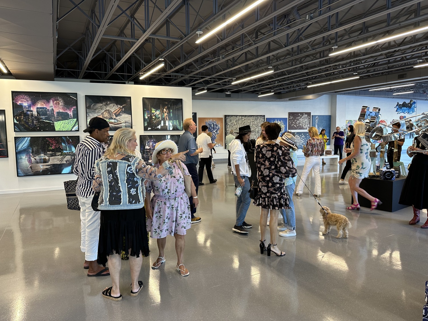 Guests admiring artwork at the Contessa Gallery, which opened in the art deco building at 1 Pond Lane in Southampton Village this summer. GREG DELIA