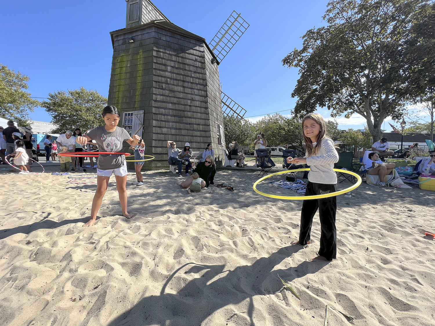 Arianna Verzosa and Claire Chmielewski in the hula hoop contest at Windmill Beach during HarborFest.  DANA SHAW