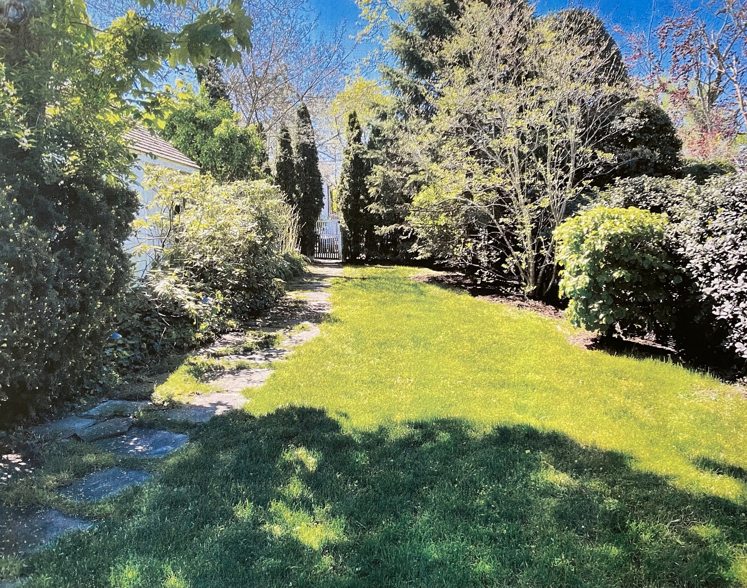 The backyard at 68 Madison Street, where a pool is planned for which a zoning variance was granted in 2021 allowing it to be five feet from the property line with 20 Union Street (at right). The gate leads to a short driveway off Jefferson Street.