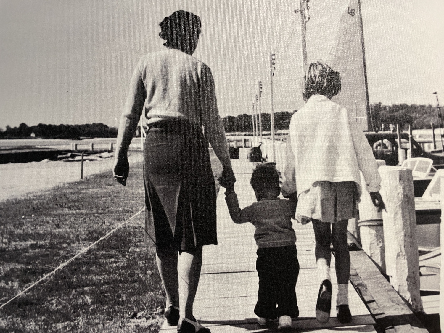 Skip Goldsmith on the docks of his family's boat yard in 1941, with his mother and cousin.