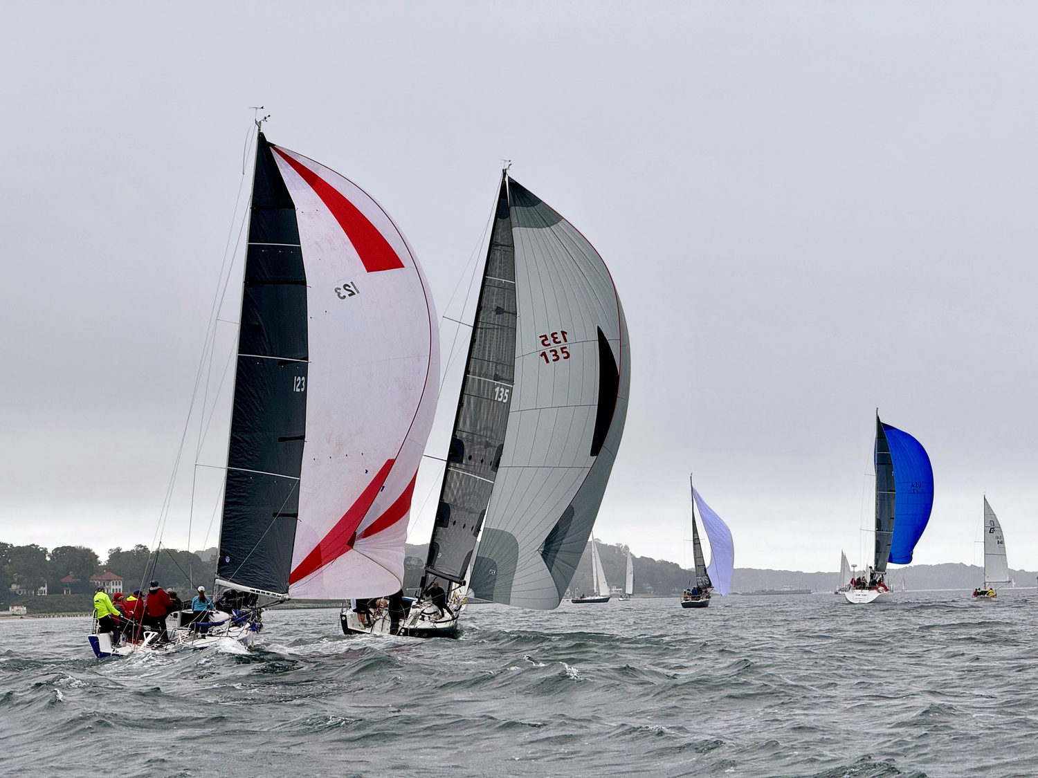 From left, Purple Haze, Obsidian, EEYS, Team Tonic sporting a blue spinnaker and Simpatico fly by Shelter Island Heights.    MICHAEL MELLA