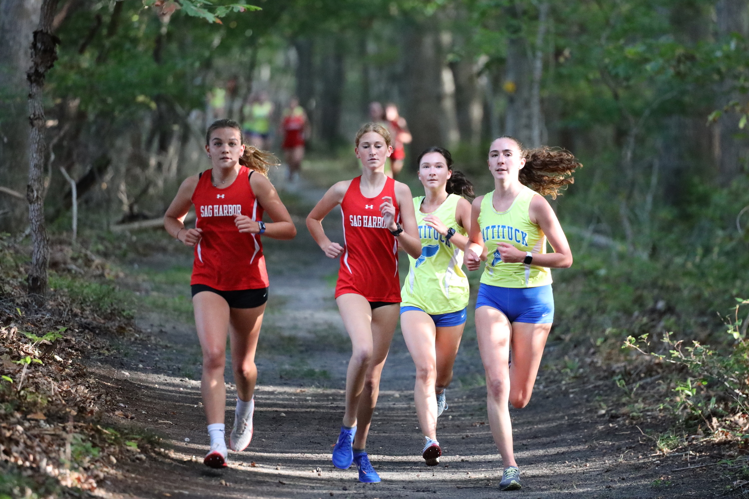 Greylynn Guyer, far left, and Sara O'Brien keep up with Mattituck's two runners in the final meet of the season.   PIERSON ATHLETICS