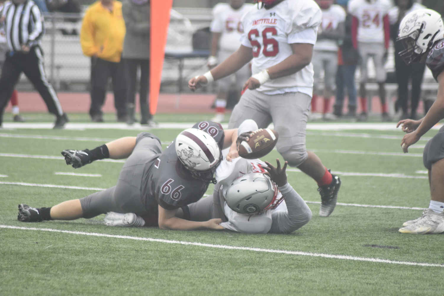 East Hampton senior Vincent Franzone takes down the Amityville quarterback for a sack. DREW BUDD