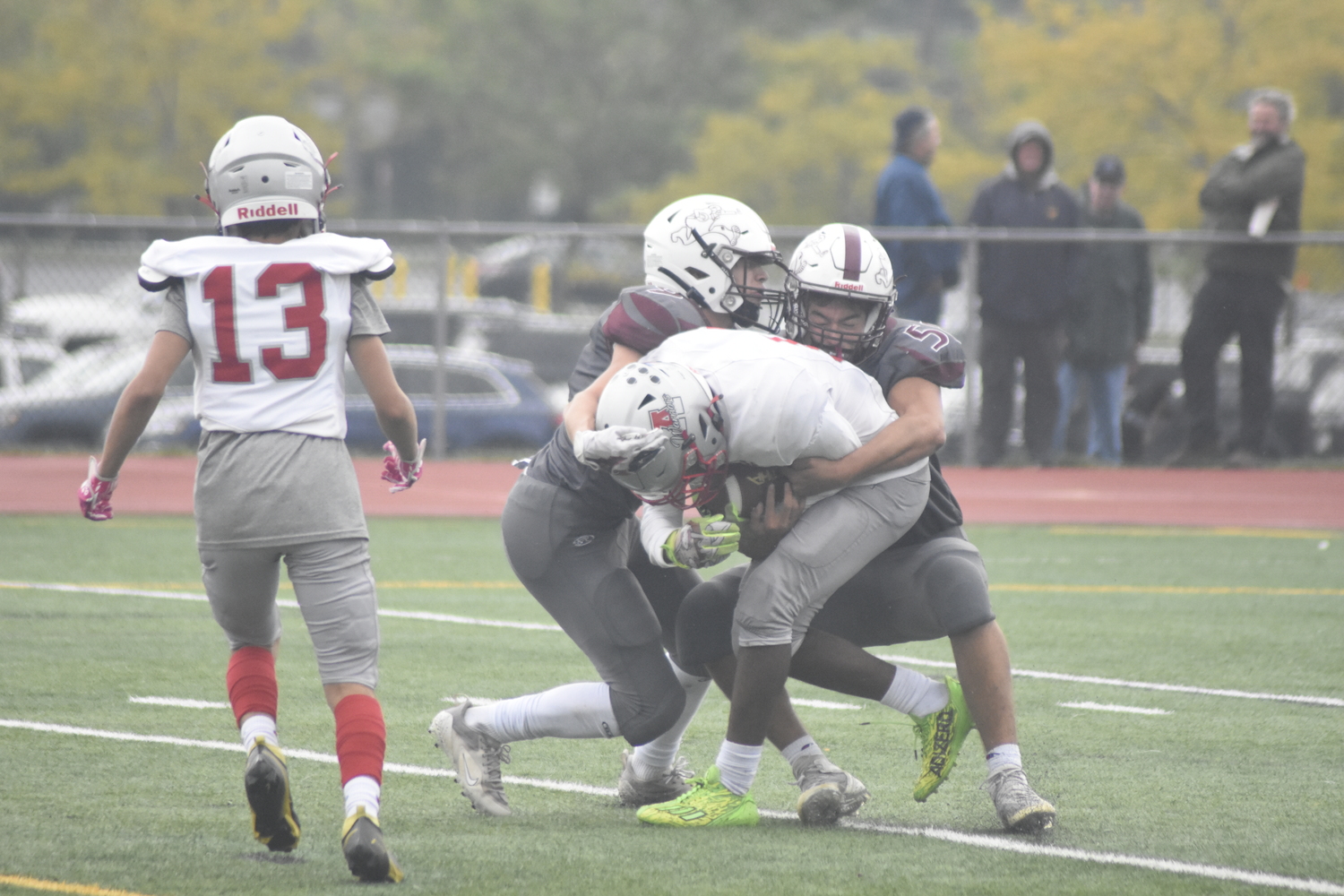 Charlie Stern, left, and Michael Mejia Coronel take down an Amityville player.   DREW BUDD