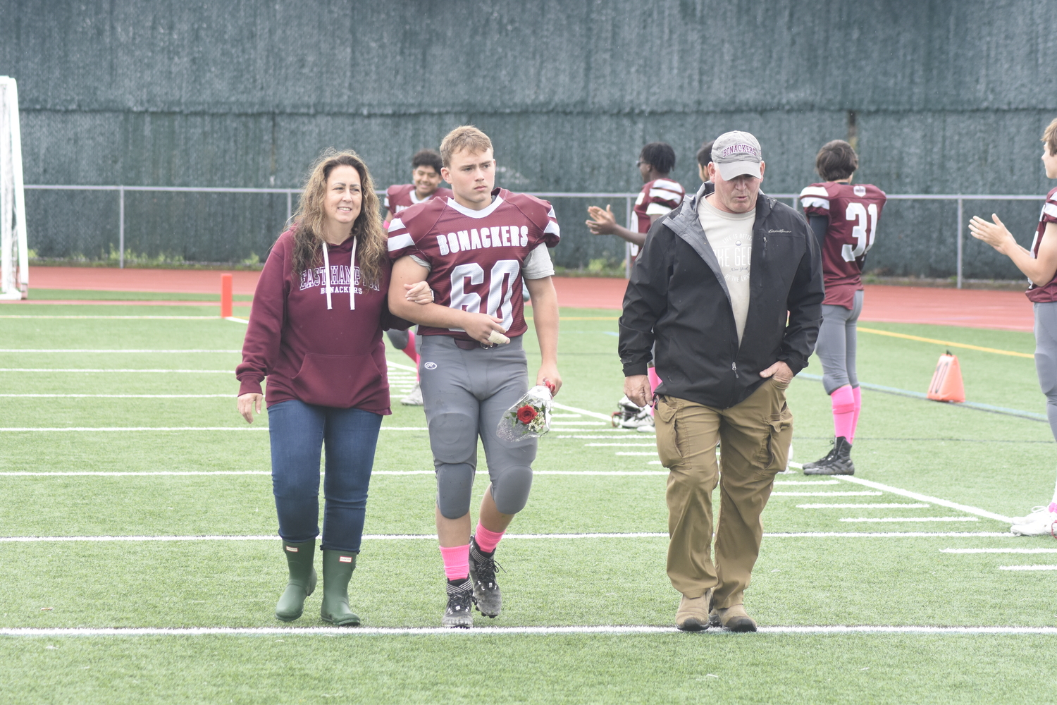 East Hampton seniors, like William McGuire and his parents here, were honored prior to Saturday's homecoming game.   DREW BUDD