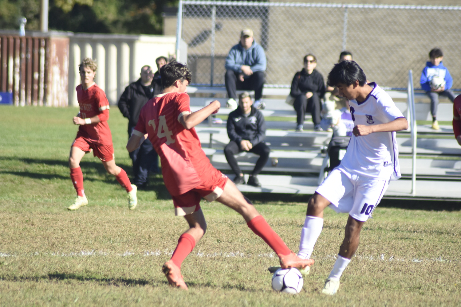 Hampton Bays senior Charlie Garcia and a Hills West player get to the ball at the same time.   DREW BUDD