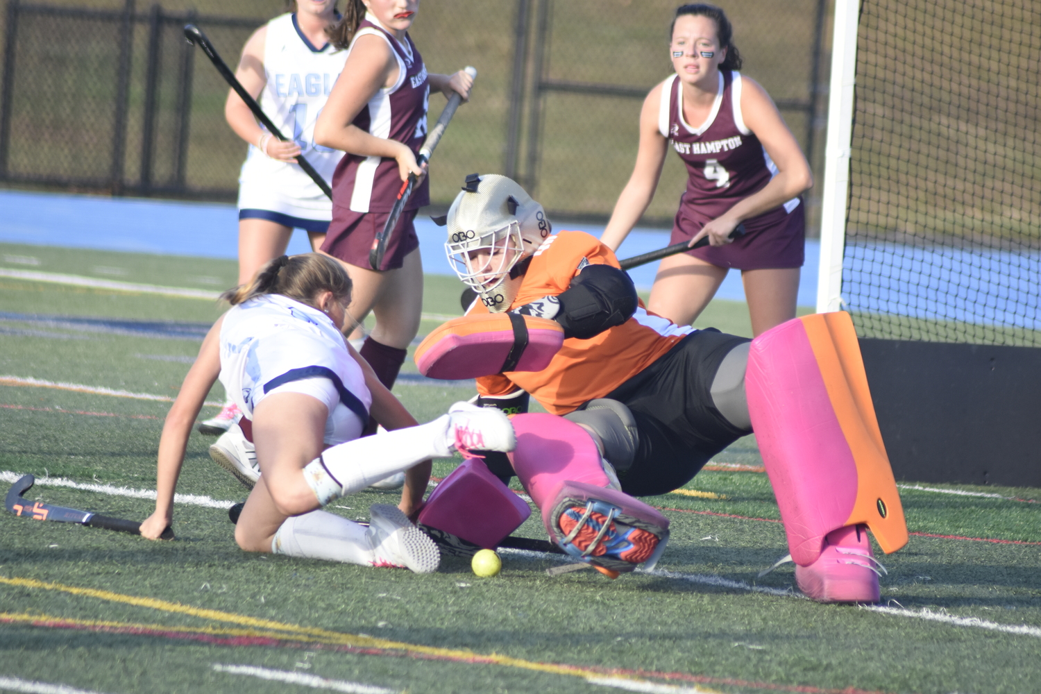 East Hampton goalie Caeleigh Schuster and a Rocky Point player get tangled up.   DREW BUDD