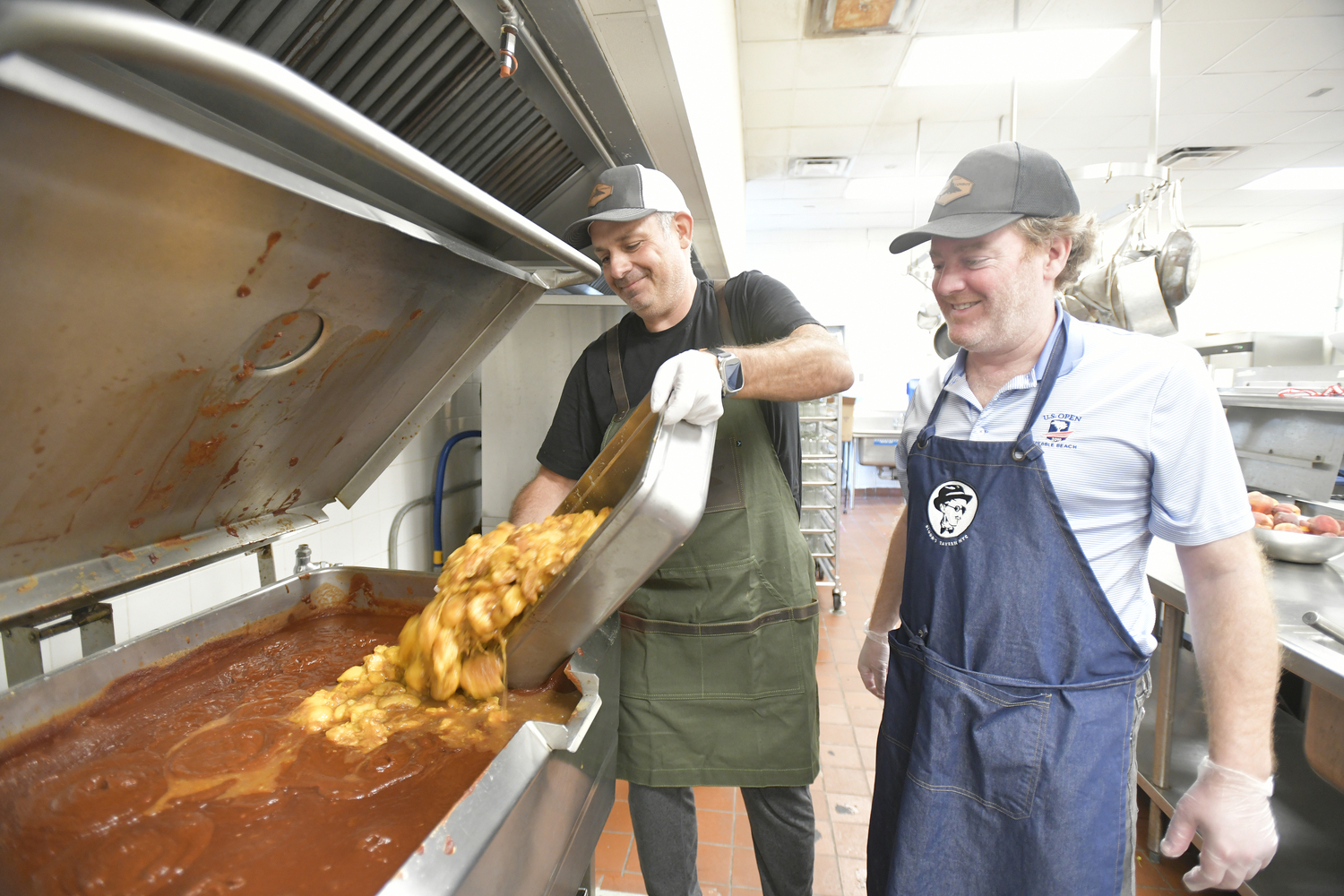 Jason Wagenheim adds the peaches to the sauce as Joe Machado look on.  DANA SHAW