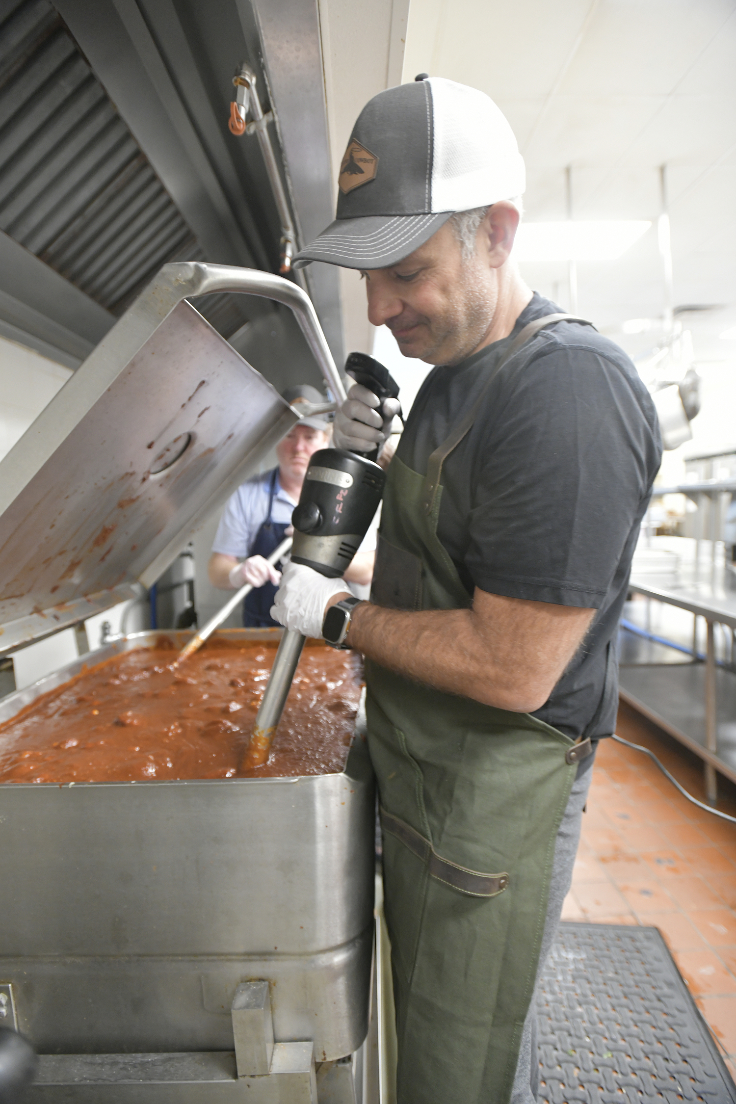 Jason Wagenheim and Joe Machado stir and blend the sauce.   DANA SHAW