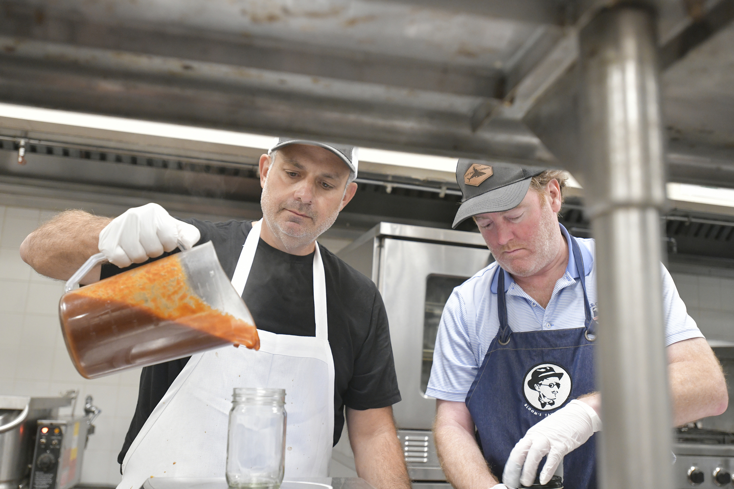 Jason Wagenheim and Joe Machado begin the bottling process.  DANA SHAW