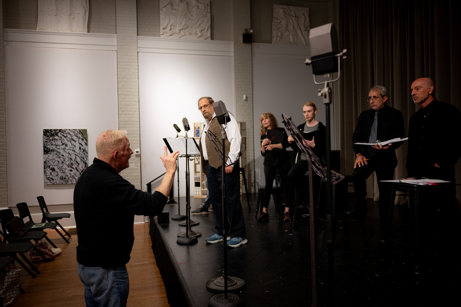 Michael Disher directing the cast of Center Stage's production of “War of the Worlds: The Panic Broadcast” during rehearsals at Southampton Arts Center. DANE DUPUIS