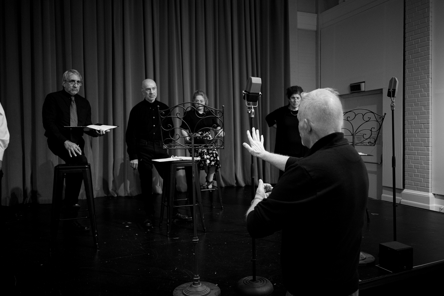 Michael Disher directing the cast of Center Stage's production of “War of the Worlds: The Panic Broadcast” during rehearsals at Southampton Arts Center. DANE DUPUIS