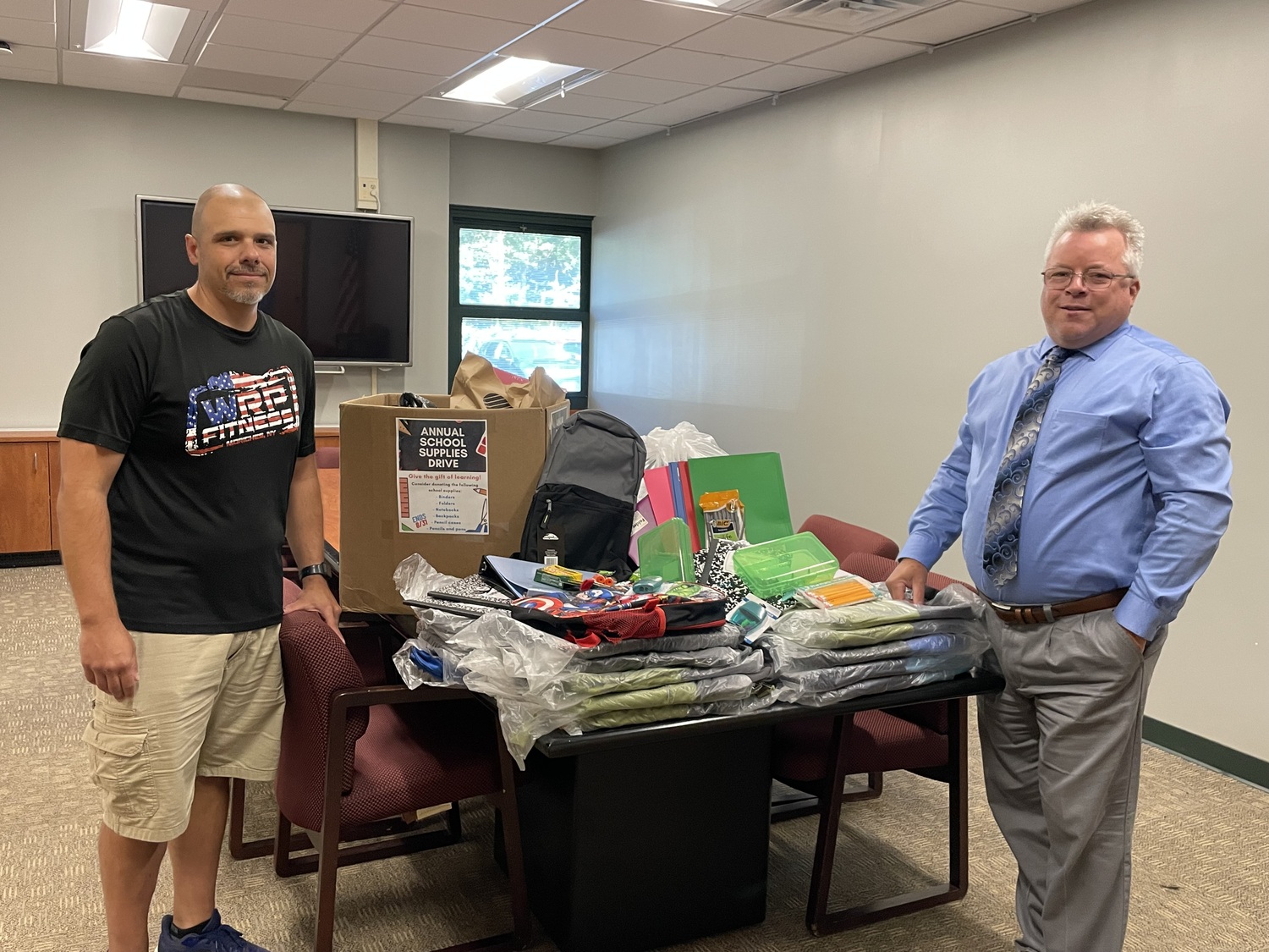 WRP Fitness member Bruce Bentley collected donations of school supplies for students at Eastport-South Manor Central School District, which he recently presented to Superintendent of Schools Joseph Steimel. The donation included folders, binders, loose leaf paper, composition books, spiral notebooks, backpacks, crayons, colored pencils, markers, pencils, pens, erasers, scissors, rulers, Post-It notes and index cards. COURTESY EASTPORT-SOUTH MANOR SCHOOL DISTRICT