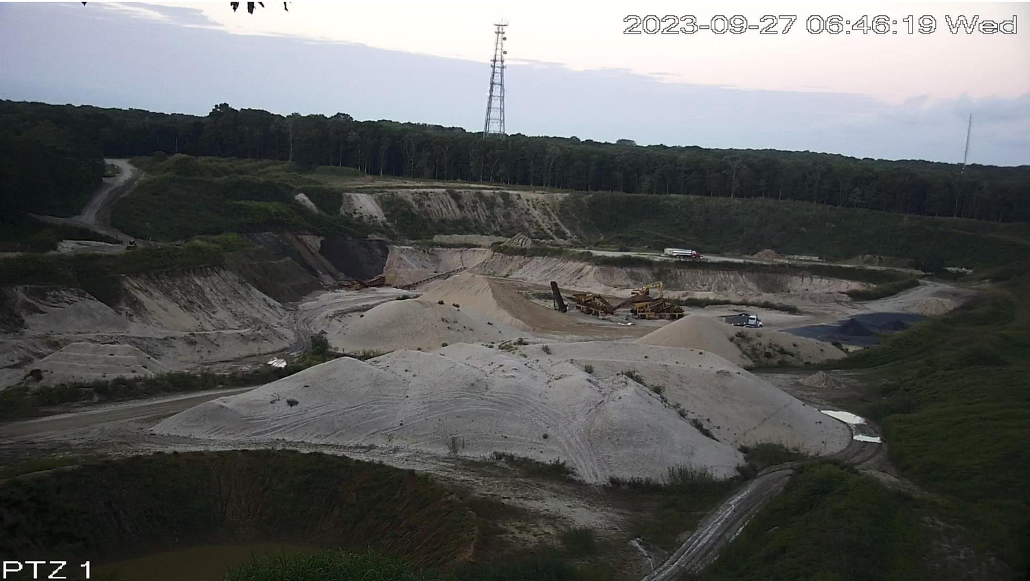 Photographs from a neighboring property show mining activity continuing at the Sand Land mine in Noyac after court orders requiring it to stop.
