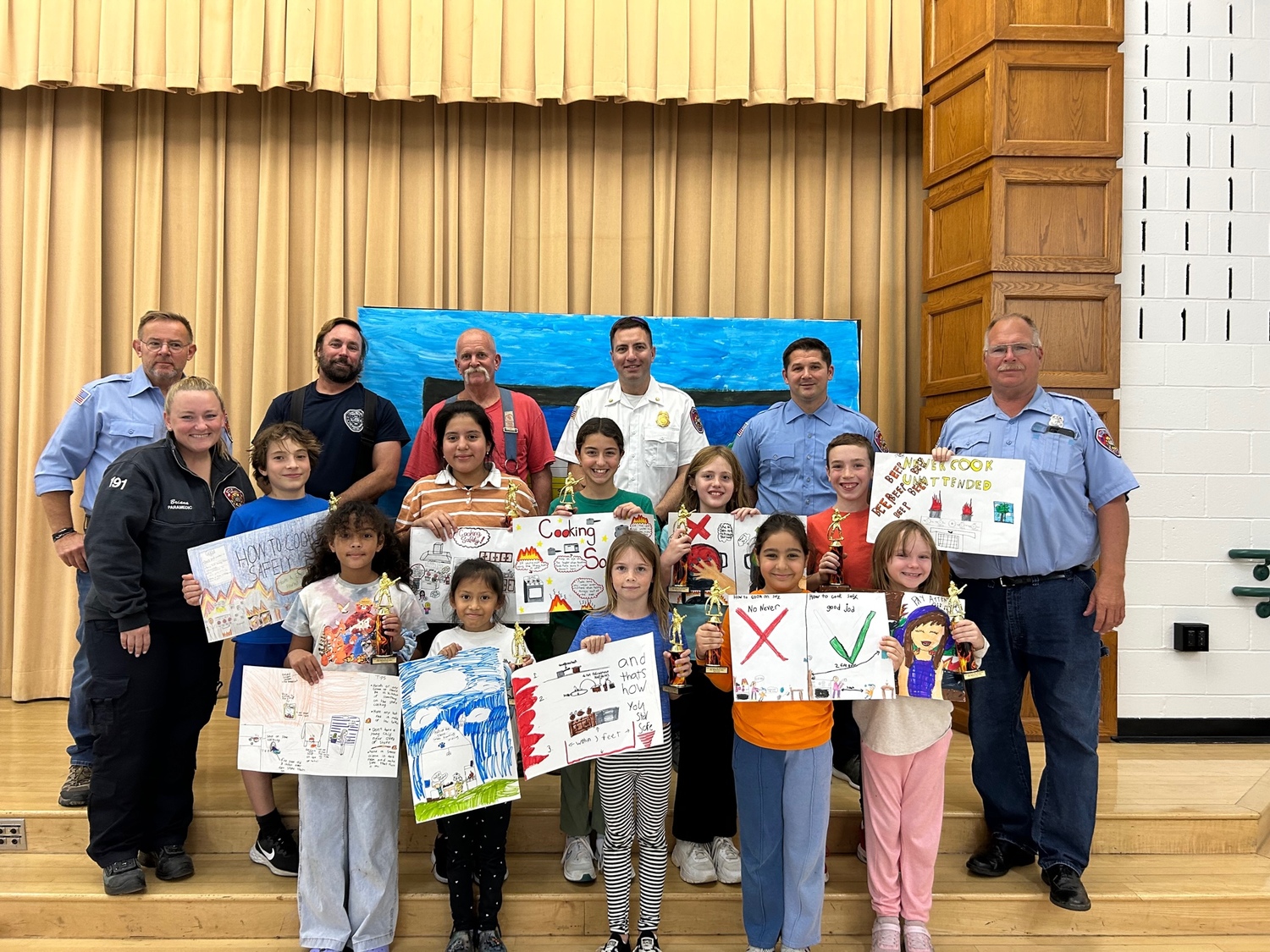 East Quogue Elementary School Students show off the trophies they won in the East Quogue Fire Department's fire safety poster contest. The trophies were presented by members of the fire department. COURTESY EAST QUOGUE SCHOOL DISTRICT