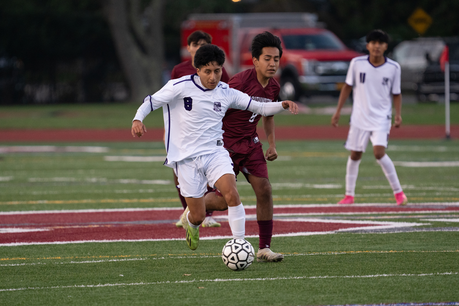 Hampton Bays senior Eddy Benenaula feels pressure from Southampton senior Erick Campohermoso.  RON ESPOSITO