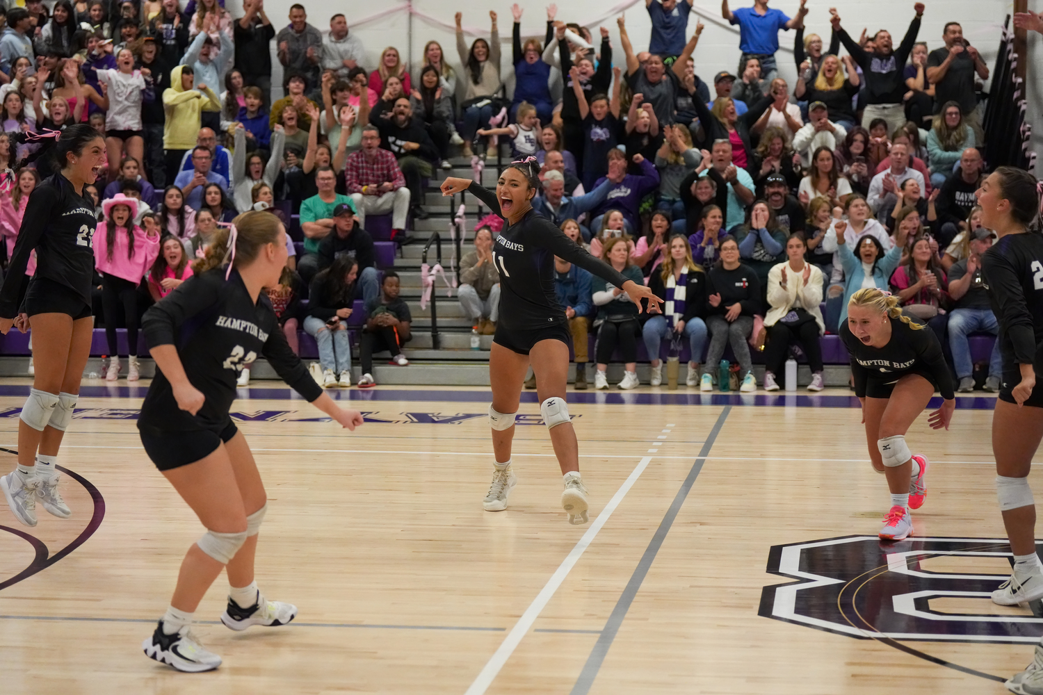 Hampton Bays' girls volleyball team celebrates its first win over Bayport-Blue Point. RON ESPOSITO