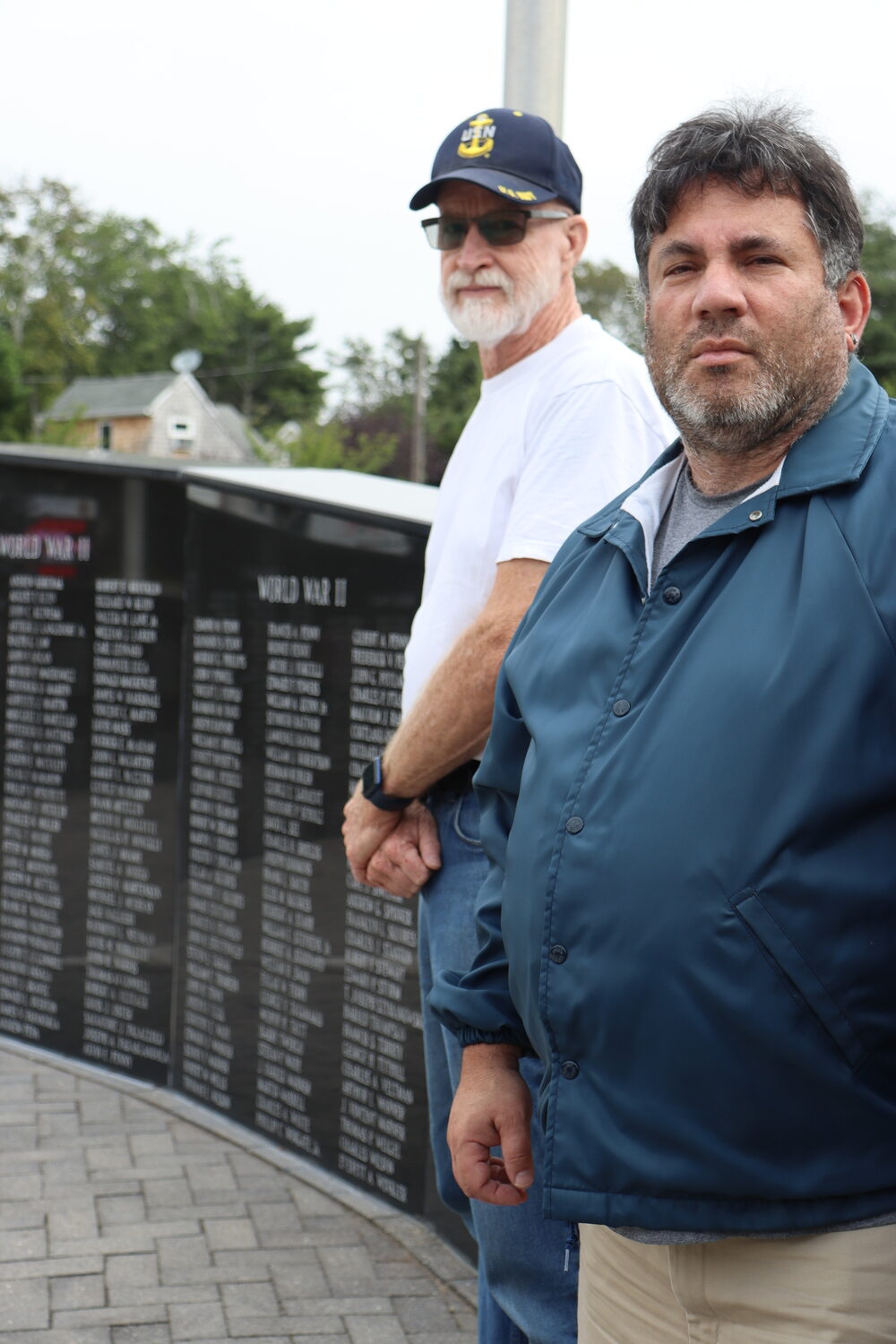 Past Commander Richie Steiber, left, and American Legion Finance Officer David Agtsteribbe at the Wall of Remembrance at the Hampton Bays American Legion Hand Aldrich Post 924 on Ponquogue Avenue. CAILIN RILEY