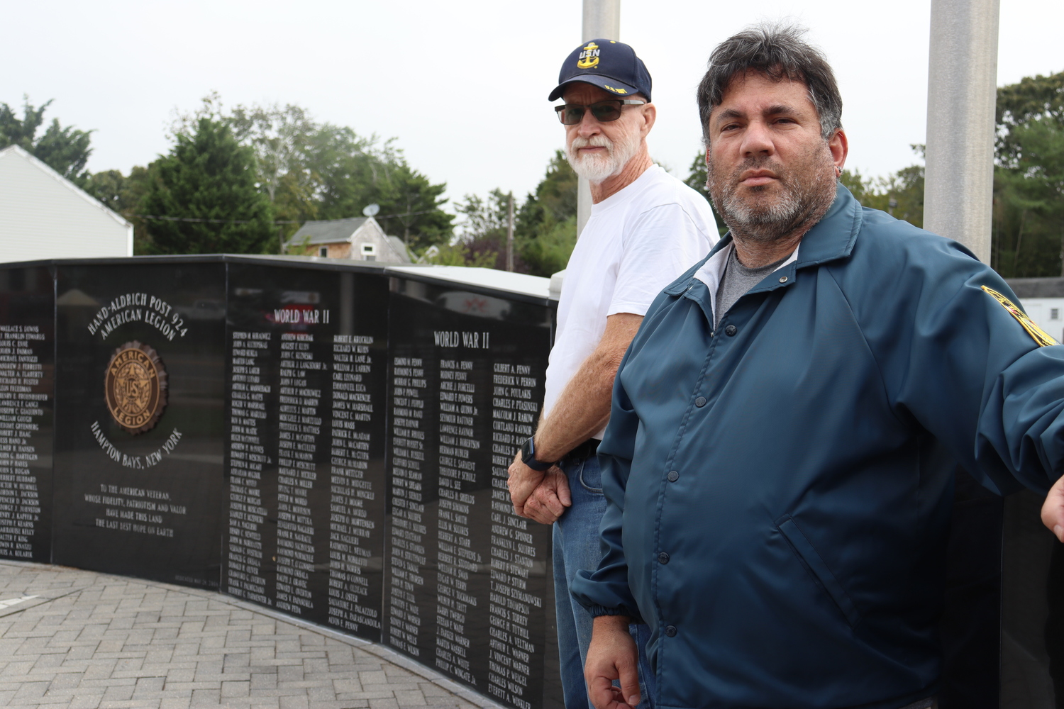 Past Commander Richie Steiber, left, and American Legion Finance Officer David Agtsteribbe at the Wall of Remembrance at the Hampton Bays American Legion Hand Aldrich Post 924 on Ponquogue Avenue. CAILIN RILEY