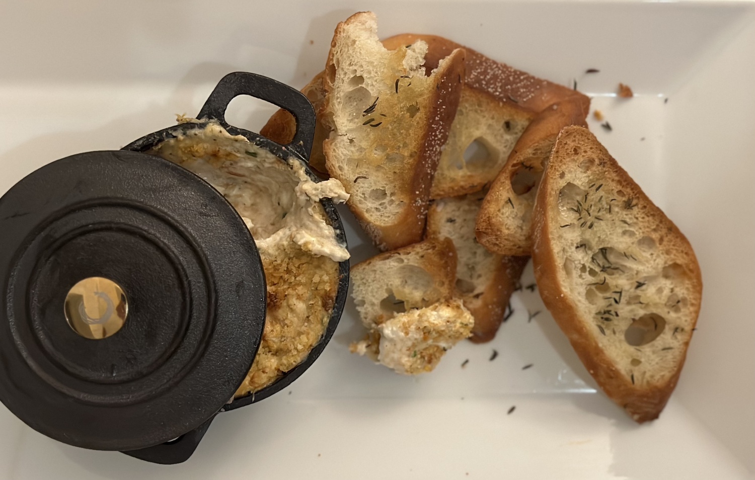 Chef Danny Schaedler's hot pan crab in a cast iron mini pot with thyme and rosemary baguette crisps. COURTESY BUOY ONE