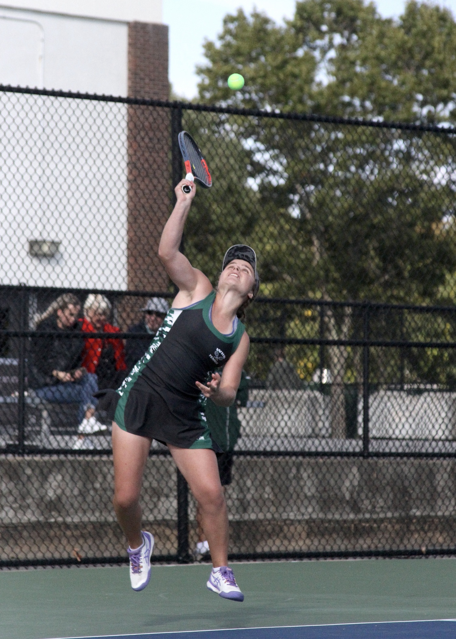 Senior Julia Stabile serves. DESIRÉE KEEGAN