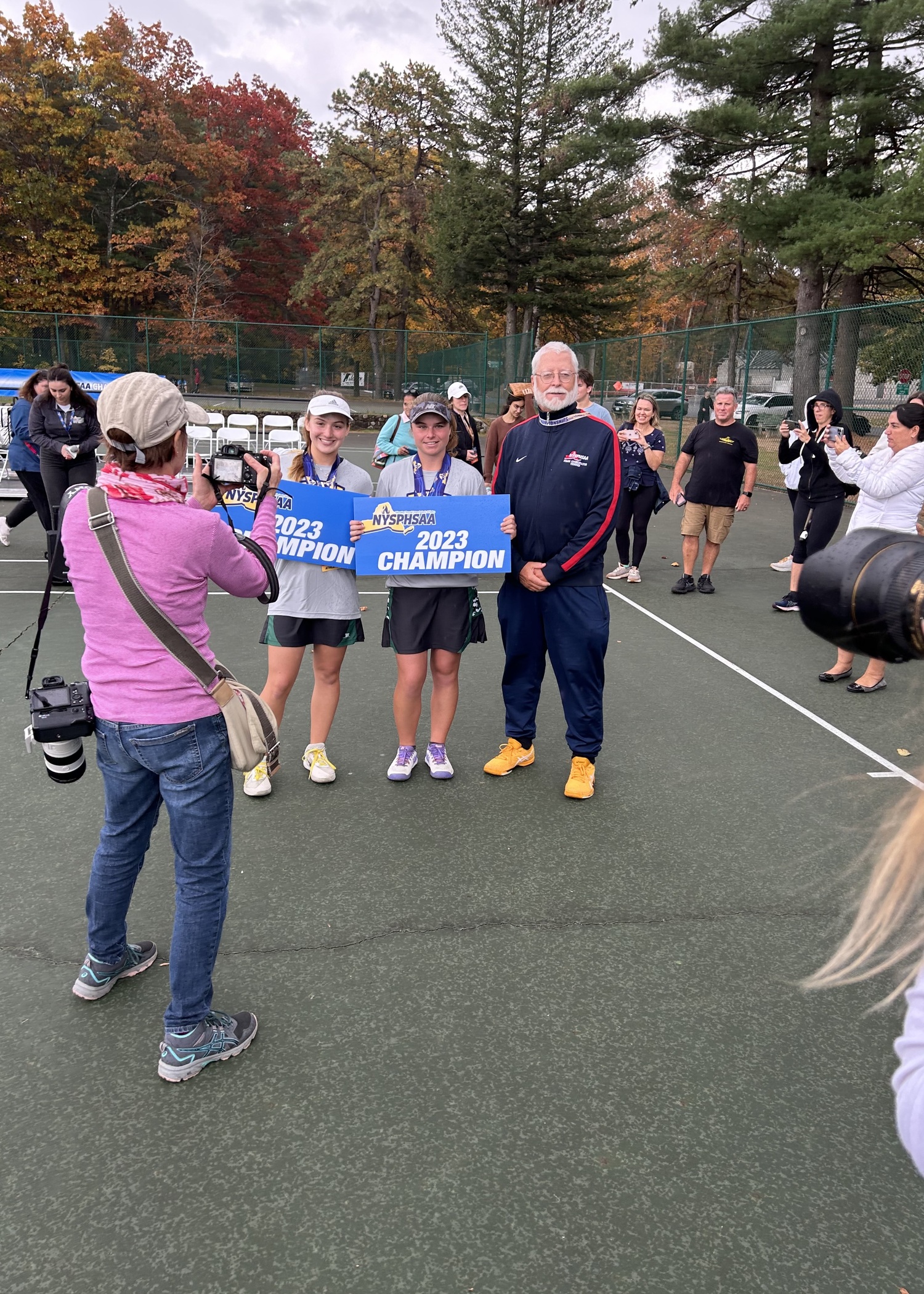 Westhampton Beach's doubles team of junior Matilda Buchen and senior Julia Stabile are swarmed by photographers after their state final victory.