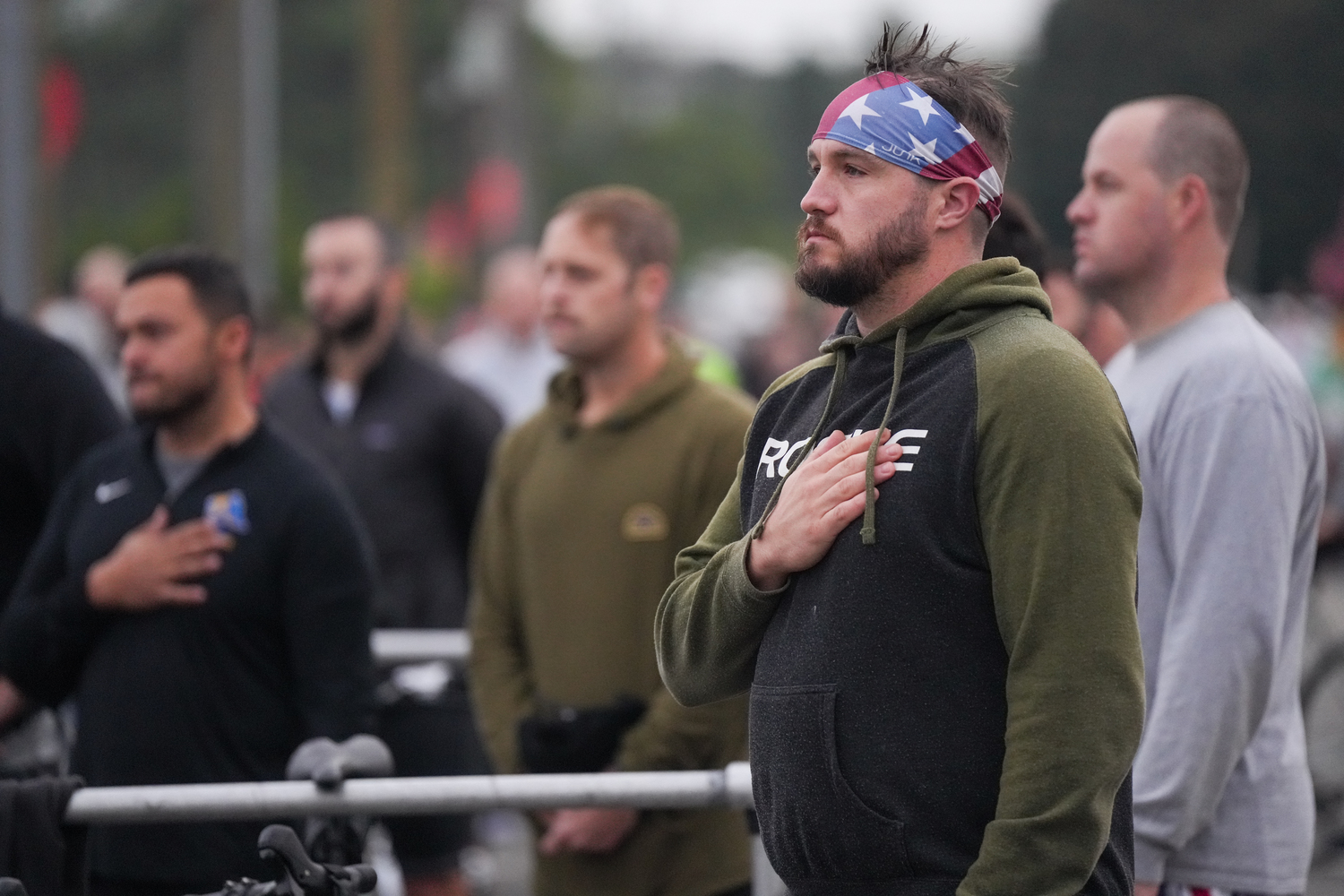 Triathletes during the national anthem just prior to the start of the MightyMan Montauk Triathlon on Sunday morning.   RON ESPOSITO
