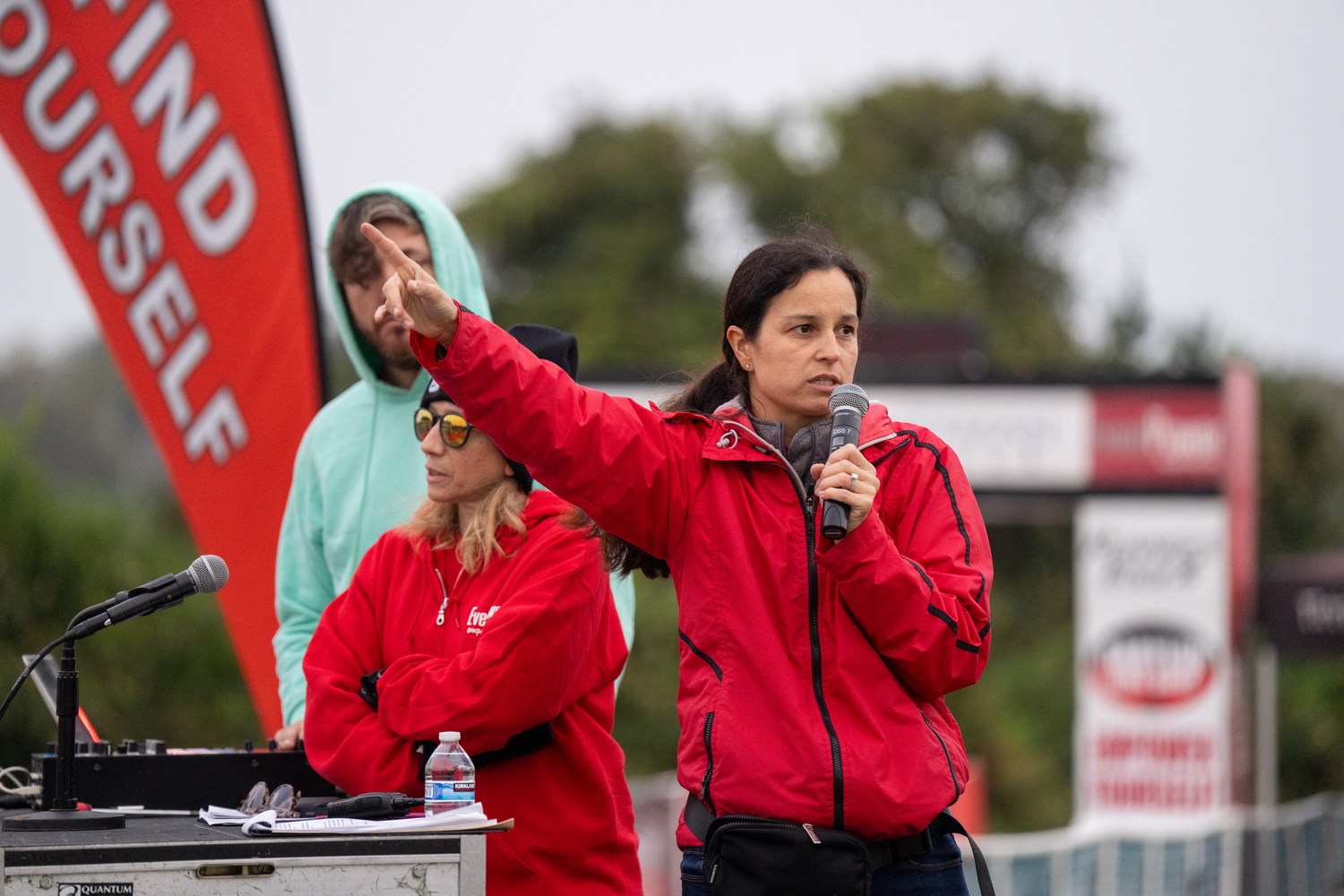 A member of EventPower, the organizer for the race, speaks.   RON ESPOSITO