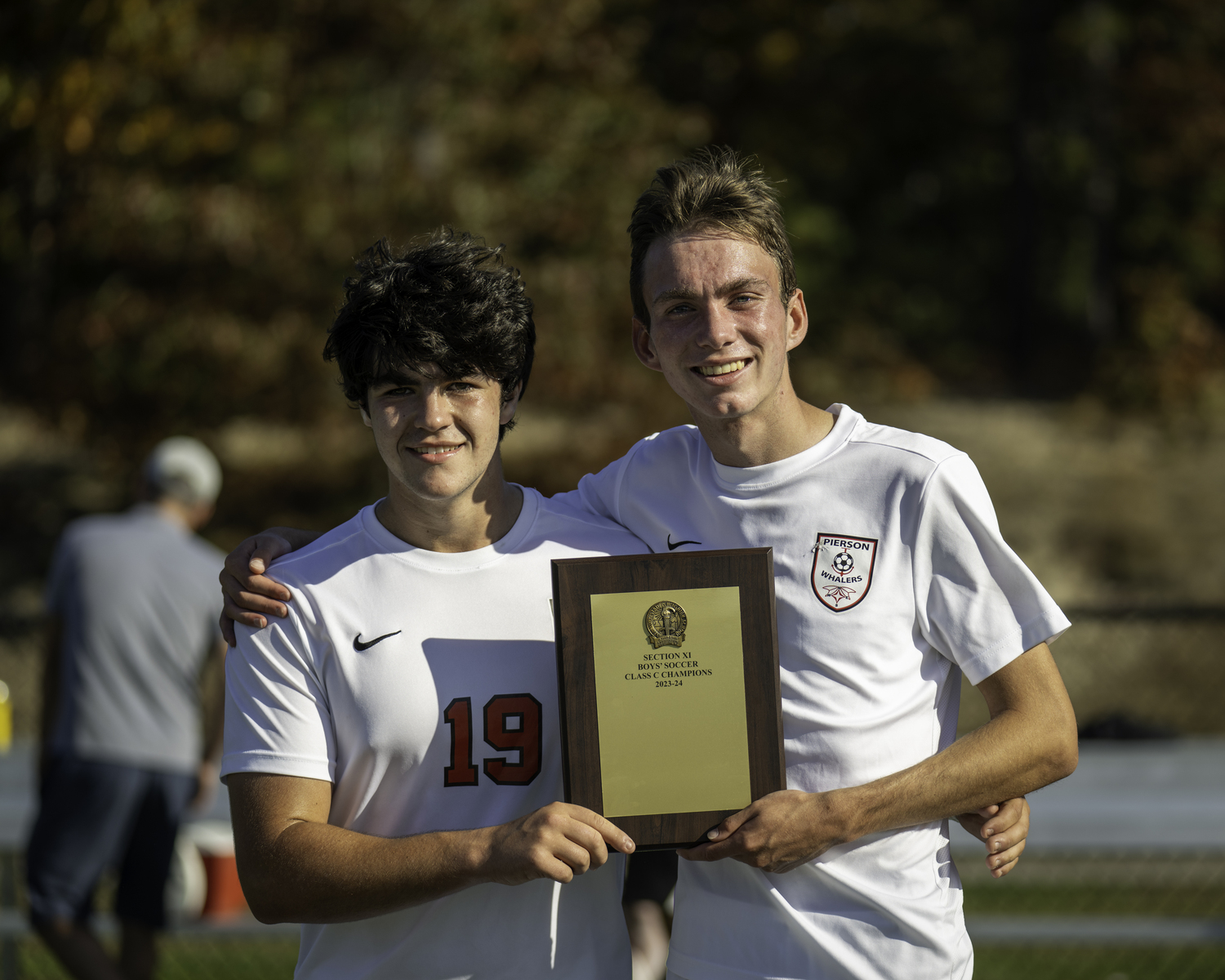 Pierson captains Gus Hayes, left, and Ryder Esposito are presented with the Suffolk County Class C Championship plaque.   MARIANNE BARNETT
