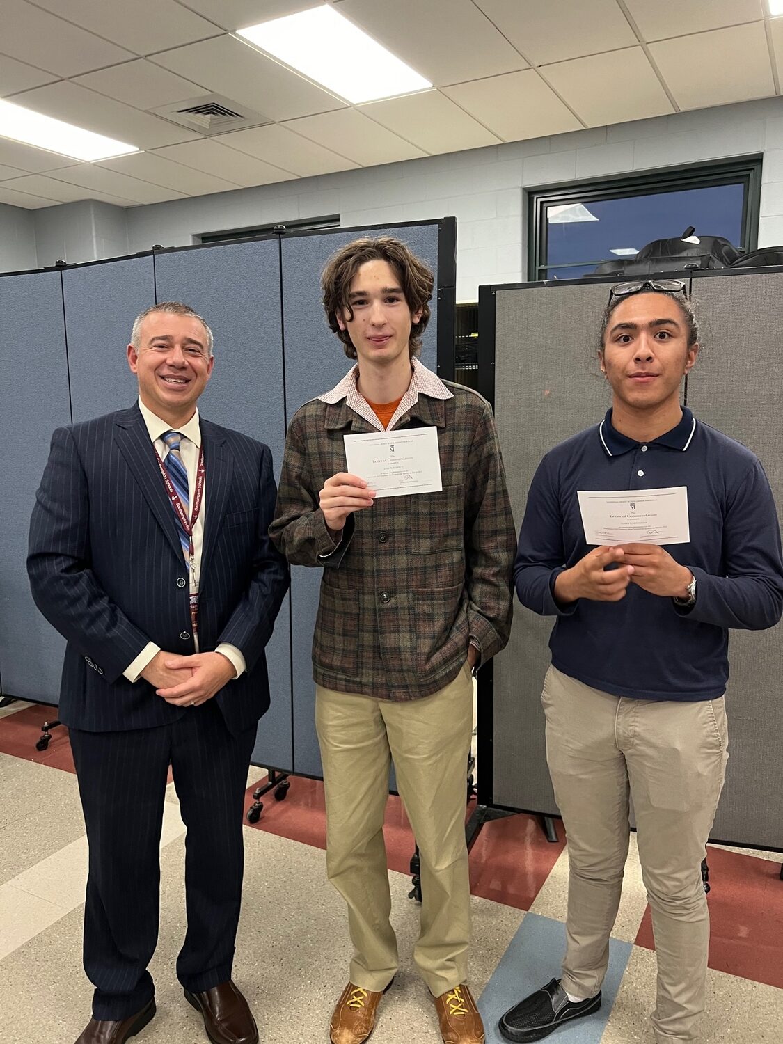 Southampton High School seniors Julian Misut and Casey Cartagena have been named National Merit Commended students and are congratulated by Principal Brian Zahn. COURTESY SOUTHAMPTON SCHOOL DISTRICT