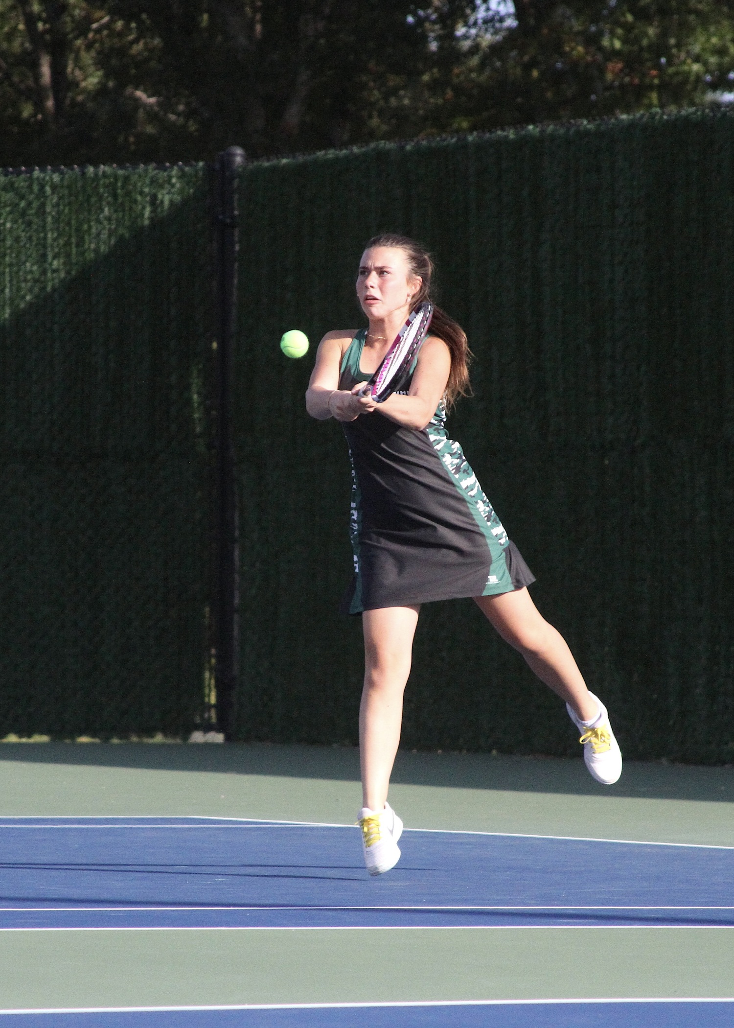 Senior Taylor Lagattolla sends the ball back over the net. DESIRÉE KEEGAN