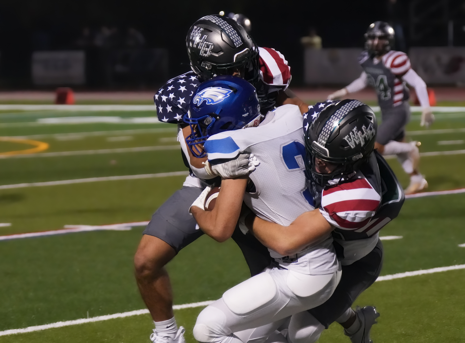 Hurricanes Gianni Amodemo, left, and Brody Schaffer team up for a big hit on a Hauppauge player.  RON ESPOSITO