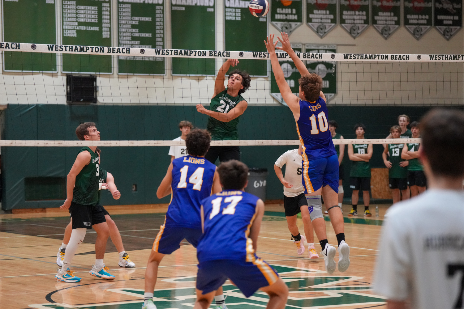 Junior middle hitter James Monserrate sends the ball past a blocker. RON ESPOSITO