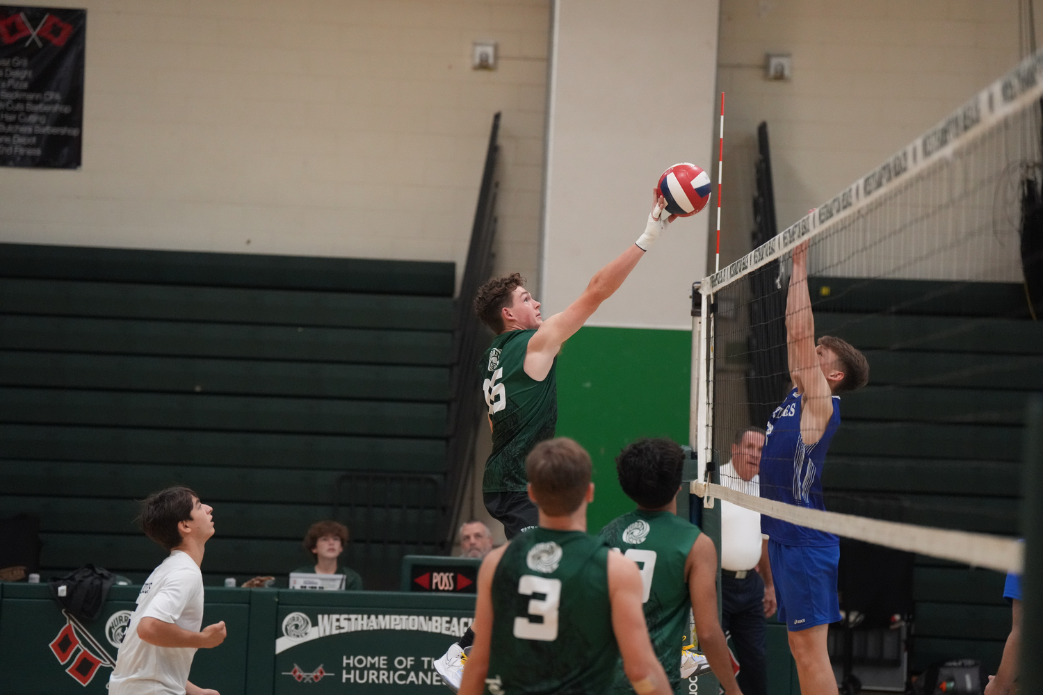 Senior outside hitter Will Jankowski spikes the ball over a block attempt. RON ESPOSITO