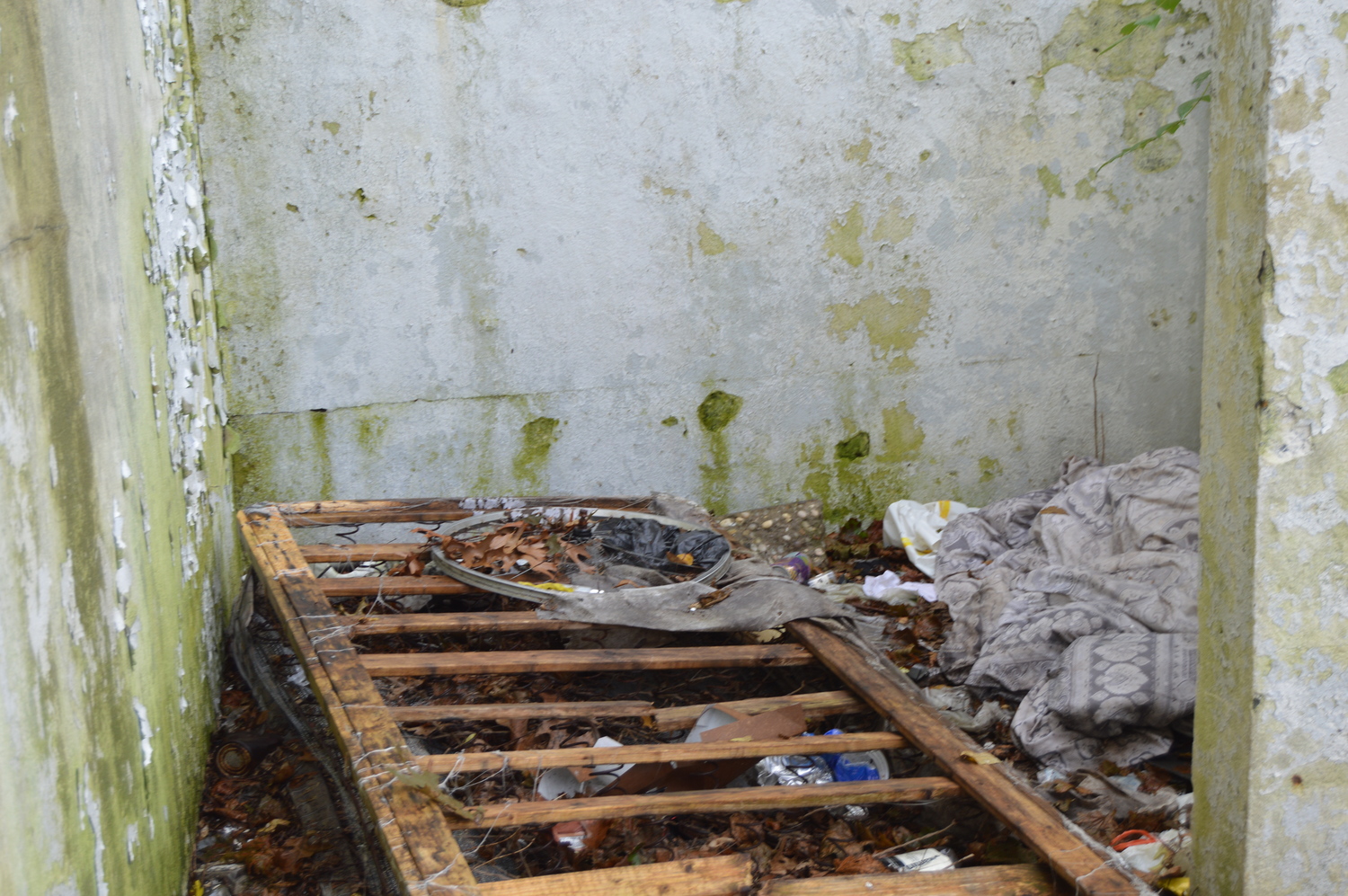 Signs of a troubled life behind shuttered Metro gas station in Westhampton. TOM GOGOLA