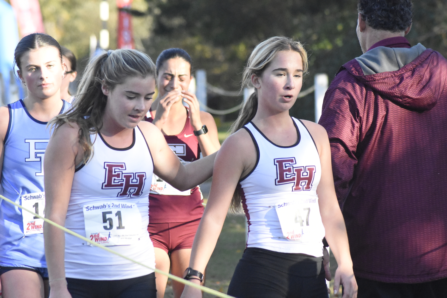 East Hampton's Ryleigh O'Donnell, left, and Dylan Cashin at the end of their final cross country race together.   DREW BUDD