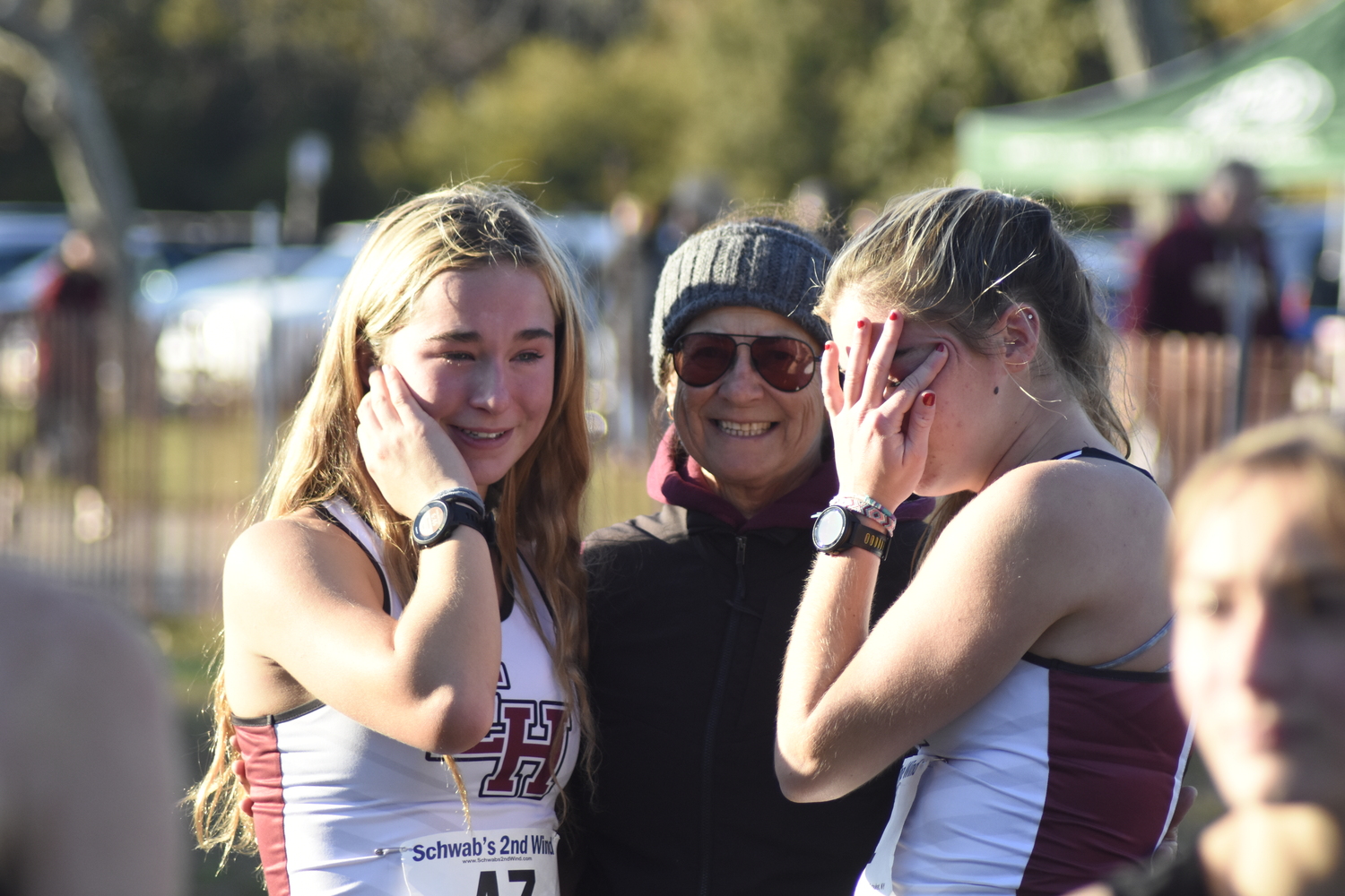 East Hampton girls cross country Diane O'Donnell consoles her two runners, Dylan Cashin, left, and Ryleigh O'Donnell.   DREW BUDD