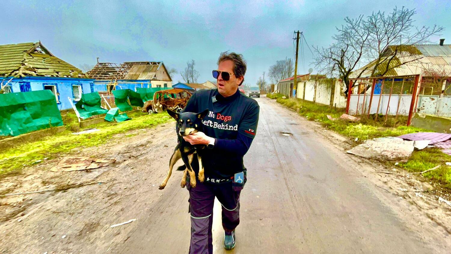No Dogs Left Behind Founder Jeff Beri carrying Checkers, one of the dogs he recently rescued from a war zone in Ukraine.
